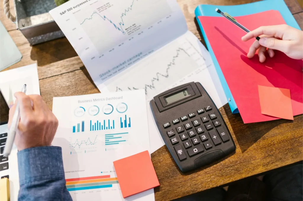 sample photo of papers on desk showing graphs that might be about property and shares investing