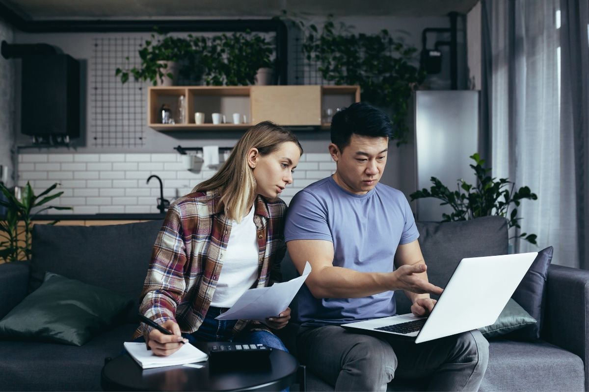 Lower Interest Rate Refinance - a homeowner reviewing mortgage statements