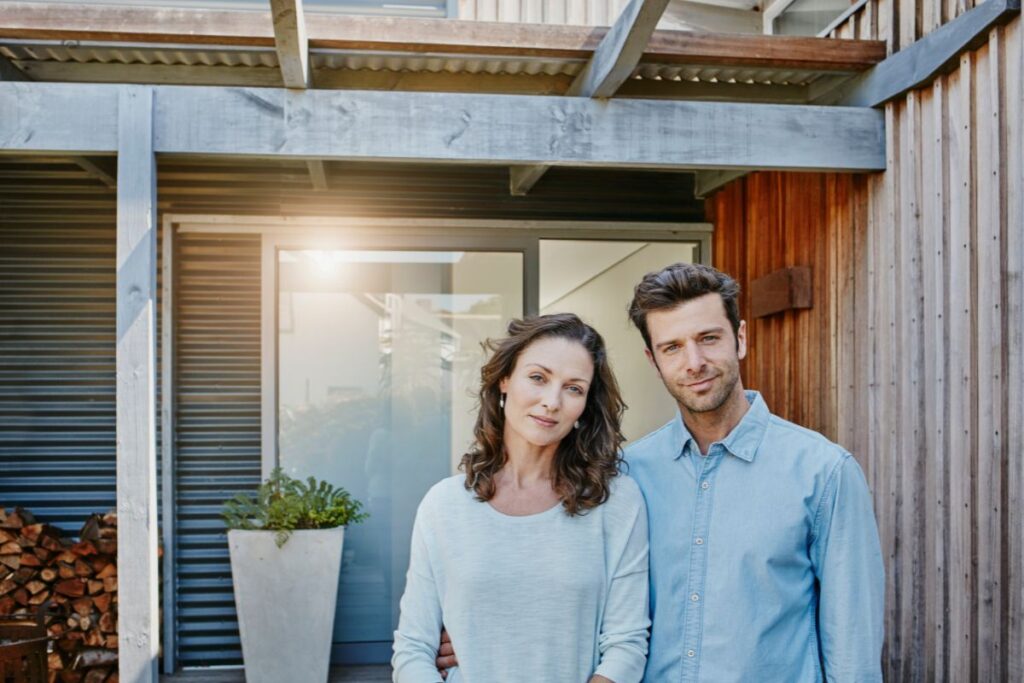 First Home Buyer Grants QLD - coins and a small house model representing first home buyer schemes