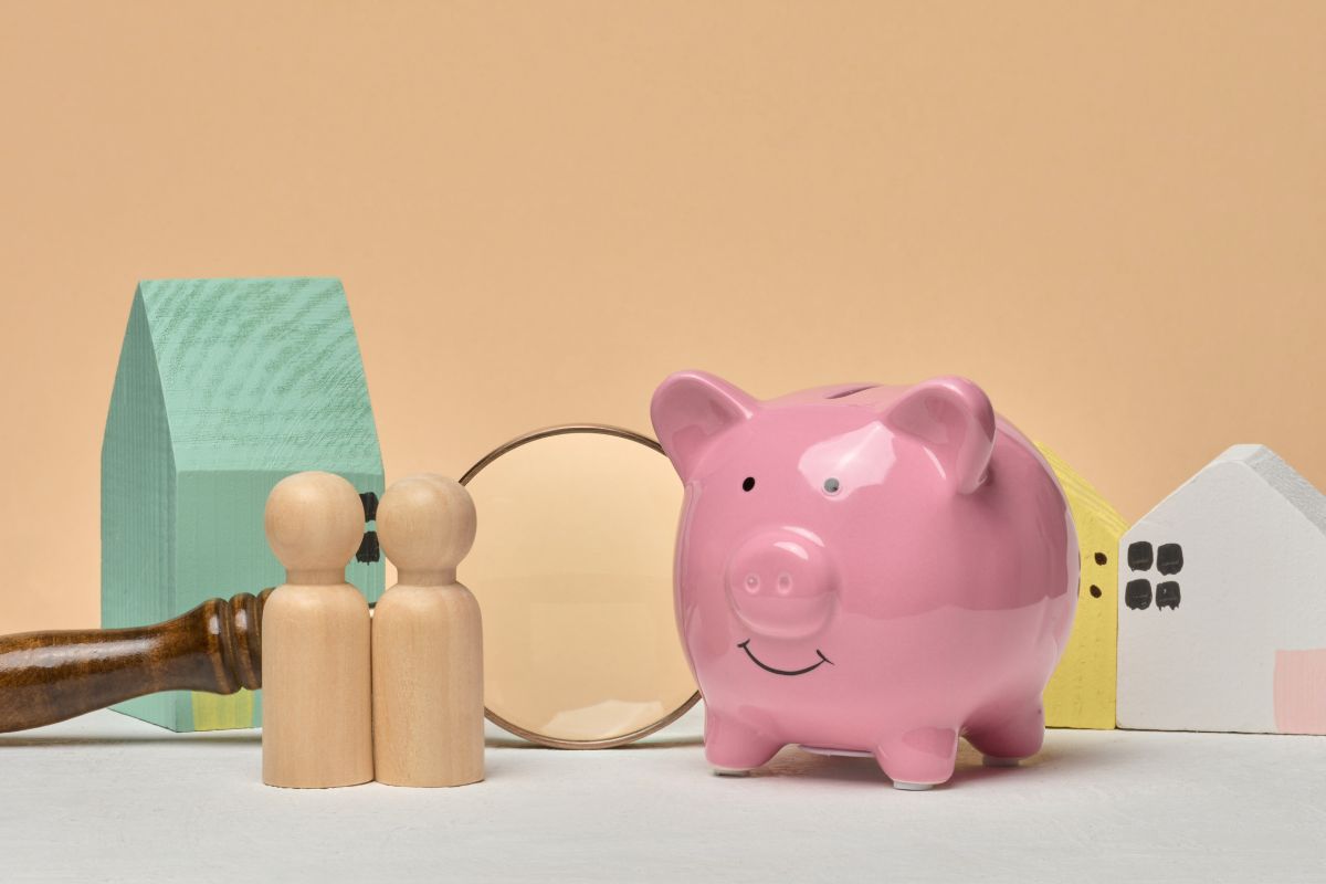 House Deposit Brisbane - a calculator and coins with a house model, a deposit calculator concept